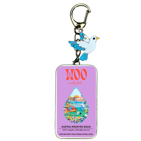 Bird charm keychain with Santal Solid Oil Balm tag